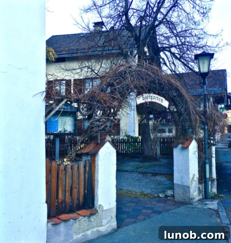 An outdoor biergarten in Oberammergau, peaceful after a busy night, awaiting new patrons.
