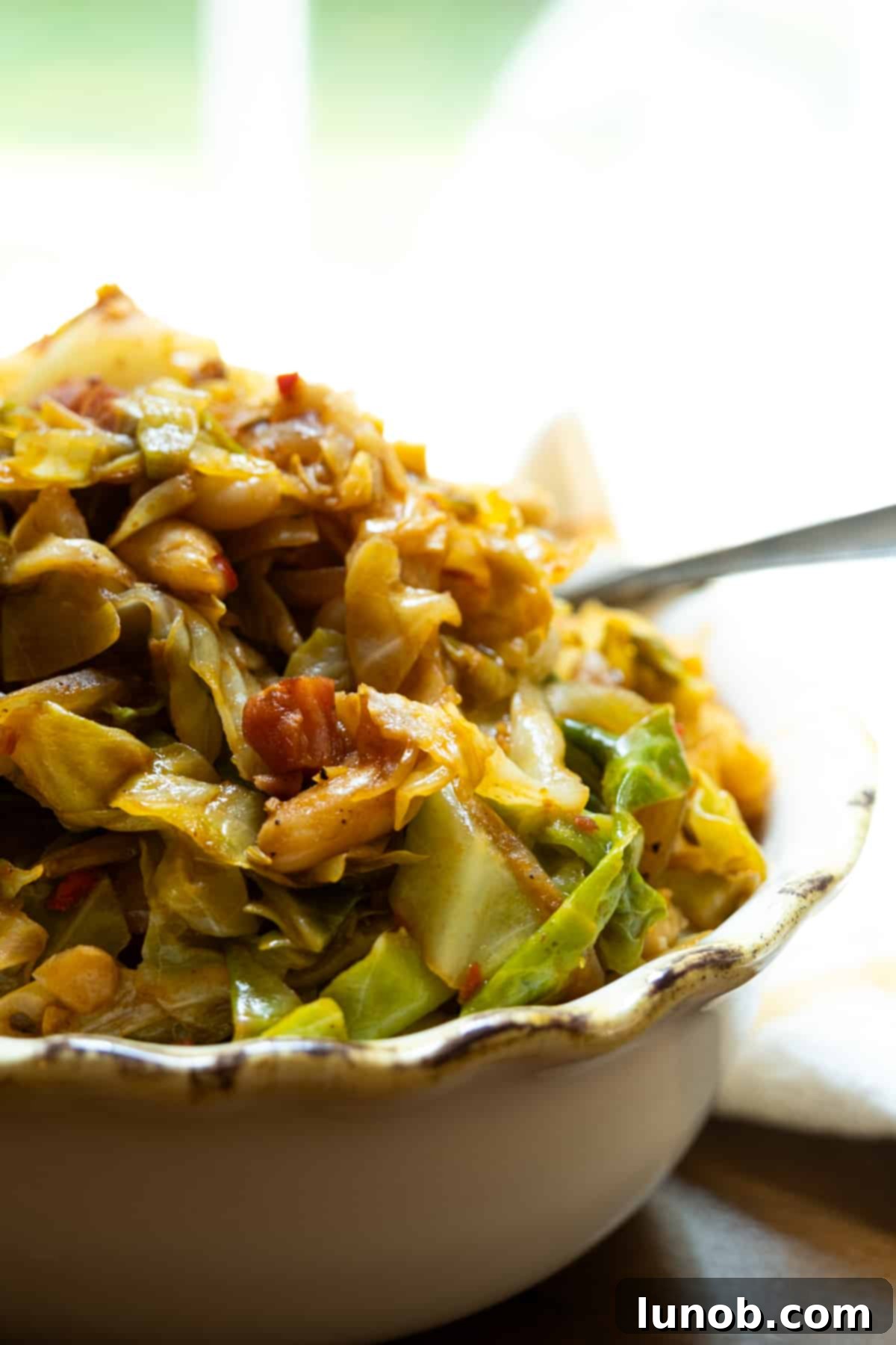Italian cabbage with crispy pancetta, rich tomato sauce, and cannellini beans ready to serve