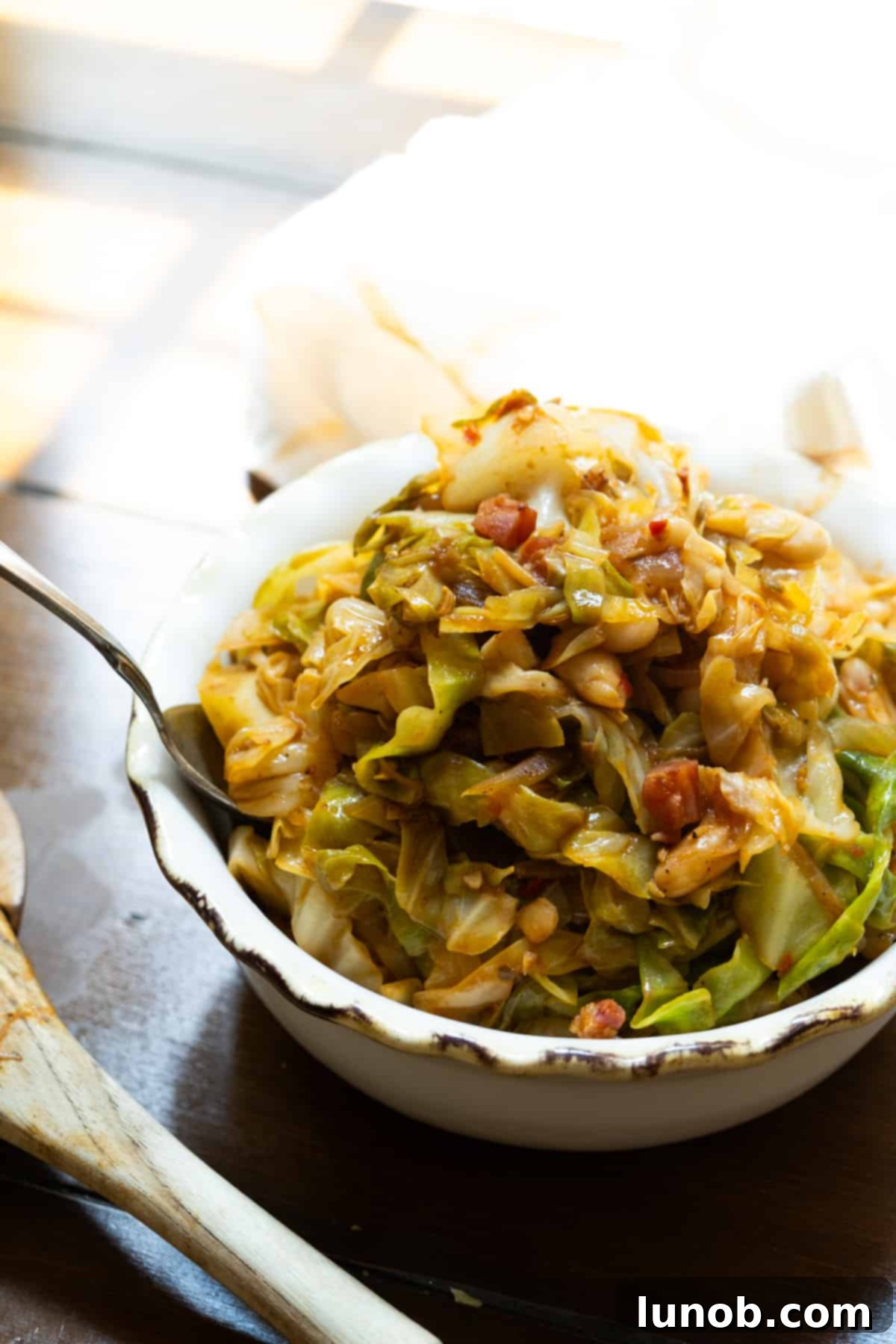 A serving of Italian cabbage with pancetta and cannellini beans in a bowl