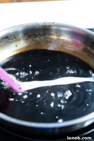 Gourmet Italian Stuffed Portobello Bake 10 balsamic glaze thickening with lazy trail left behind after spatula dragged through