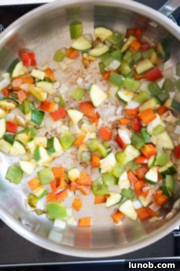Wholesome Lentil Egg Breakfast 3 Sauteed onions, peppers, and zucchini in a saucepan