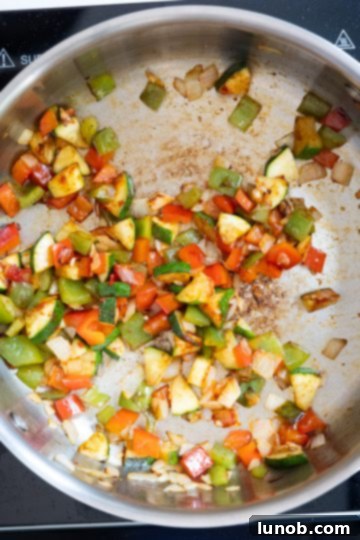 Wholesome Lentil Egg Breakfast 4 Sauteed vegetables with minced garlic added to the pan