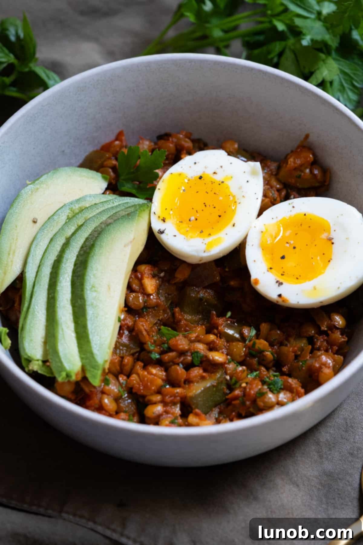 Wholesome Lentil Egg Breakfast 8 Healthy eggs and lentils breakfast with avocado slices and fresh parsley