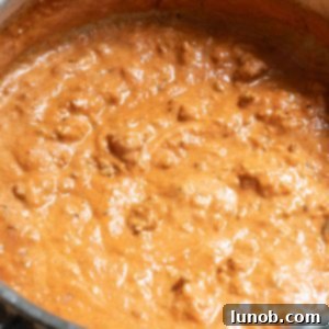 Italian pink sauce with sausage in sauce pot