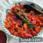 Close-up of Chicken Cacciatore (Pollo alla Cacciatore) garnished with fresh herbs