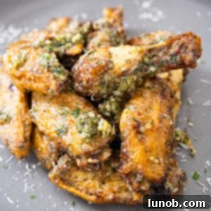 Crispy Air Fryer Garlic Parmesan Wings 9 air fryer garlic parm wings piled neatly on a plate