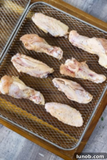 Crispy Air Fryer Garlic Parmesan Wings 5 Air fryer basket filled with seasoned chicken wings ready for cooking