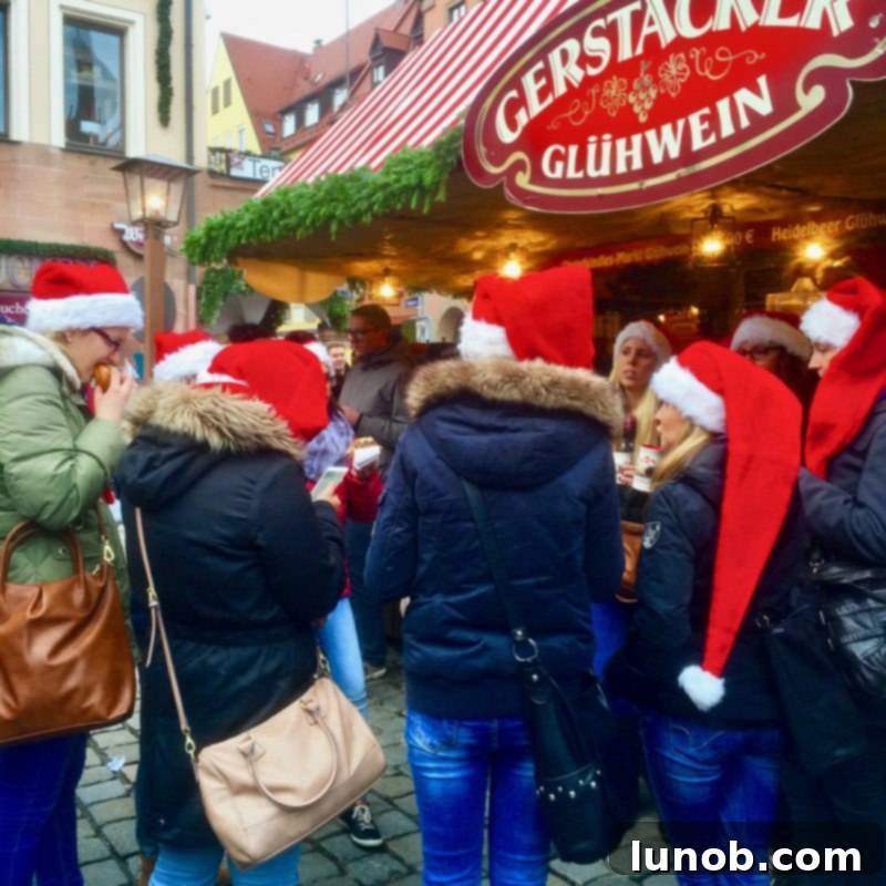 Gluhwein German Mulled Wine Munich Nuremberg Tradition 8 Joyful people enjoying the Christmas spirit at a festive market