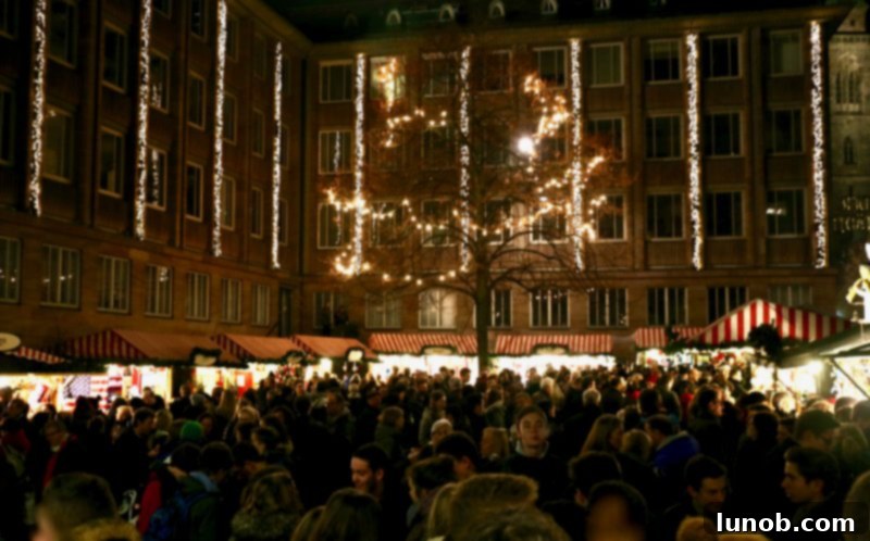 Gluhwein German Mulled Wine Munich Nuremberg Tradition 9 Crowds enjoying warm Glühwein and traditional Christmas foods at a market