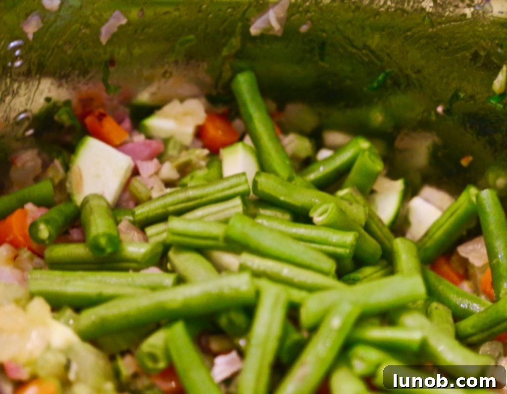 Authentic Italian Minestrone: The Definitive Classic Recipe 11 Adding diced potatoes to the Minestrone soup, which will become tender and creamy.