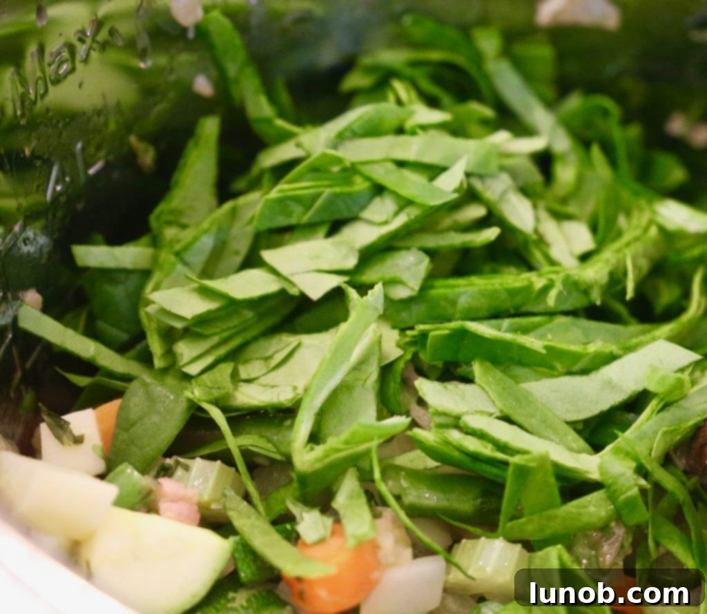 Authentic Italian Minestrone: The Definitive Classic Recipe 13 Adding chopped cabbage to the hearty Minestrone soup.