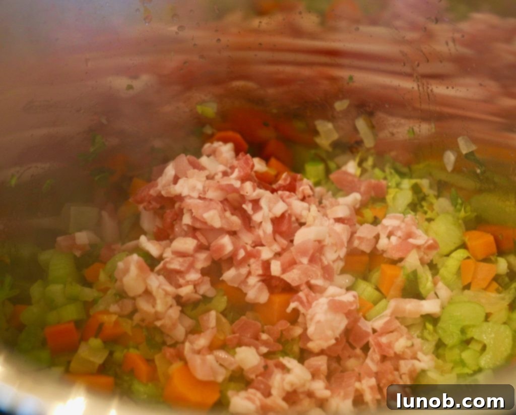 Authentic Italian Minestrone: The Definitive Classic Recipe 8 Sautéing the minestrone base ingredients: onions, garlic, carrots, celery, and pancetta.
