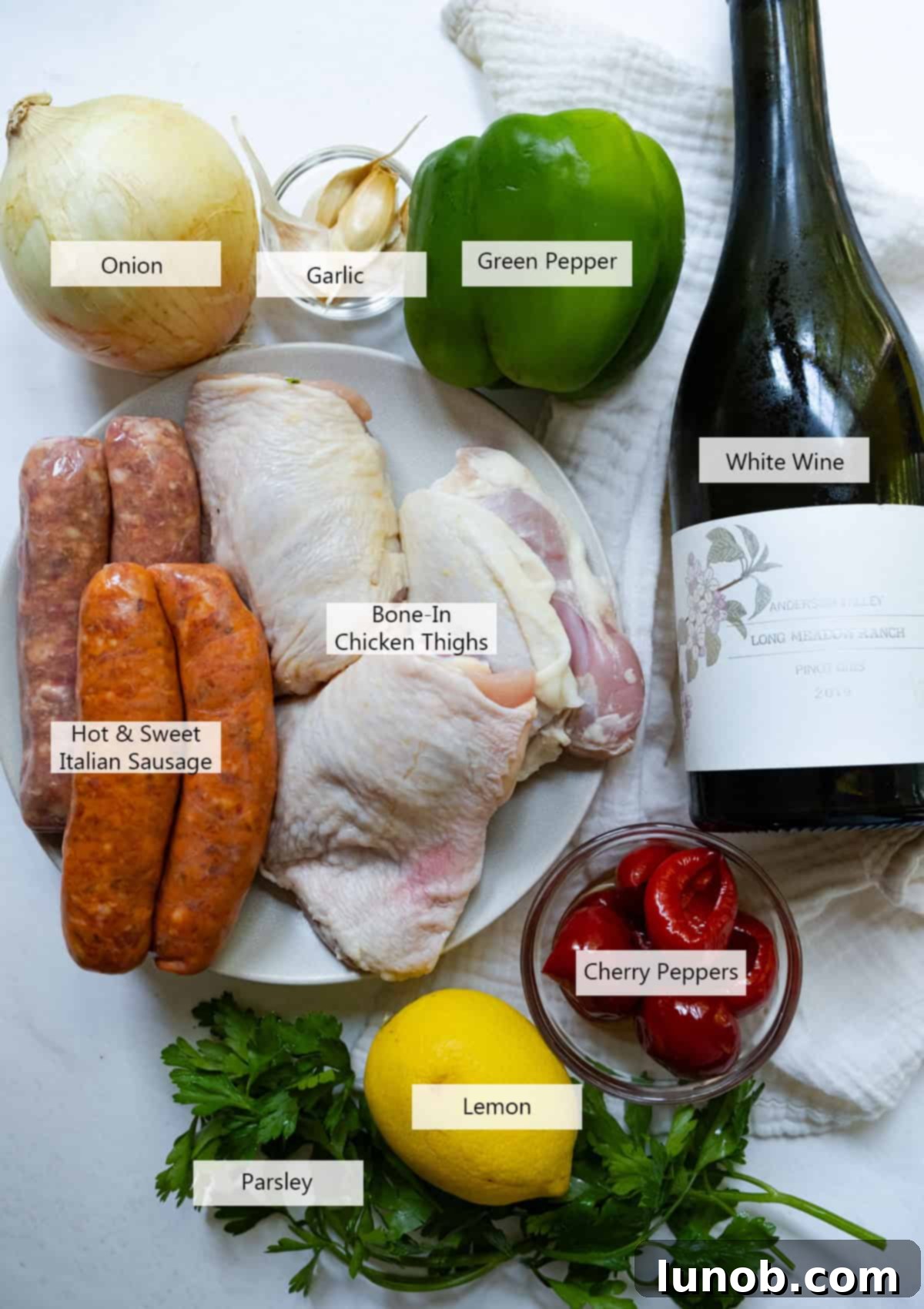 Homemade Restaurant-Style Chicken Scarpariello Perfection 3 Assorted ingredients for Chicken Scarpariello including chicken thighs, sausages, bell peppers, onions, garlic, and cherry peppers.