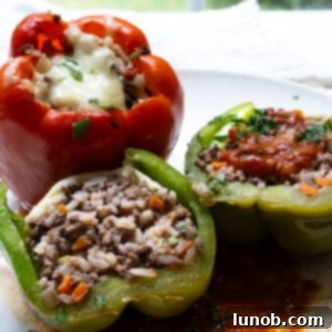 Italian stuffed peppers topped with mozzarella cheese and rich tomato sauce, ready to serve.