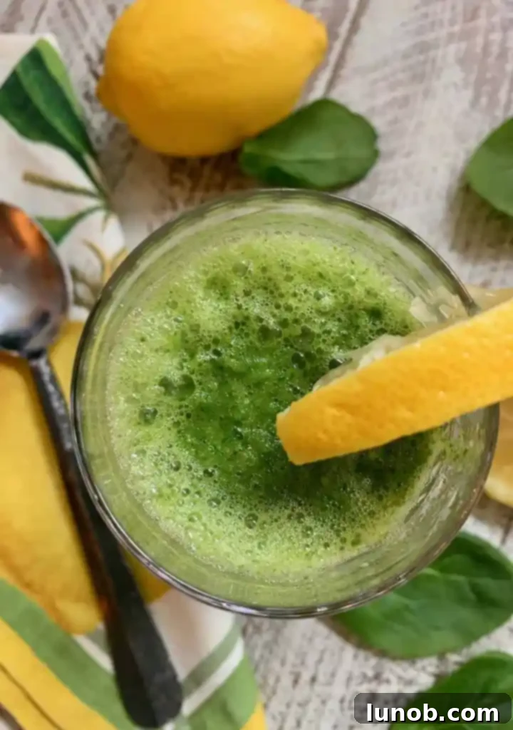 Close-up of a refreshing Pineapple, Spinach, and Ginger Super Detox Smoothie in a glass.