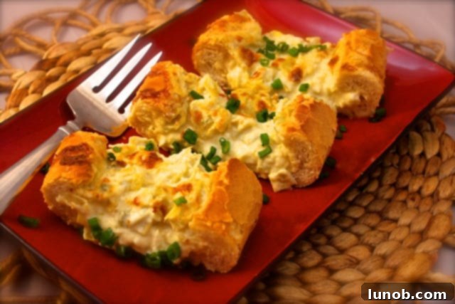 Winning Game Day Eats For Every Fan 13 Golden brown cheesy artichoke and garlic bread on a cutting board.