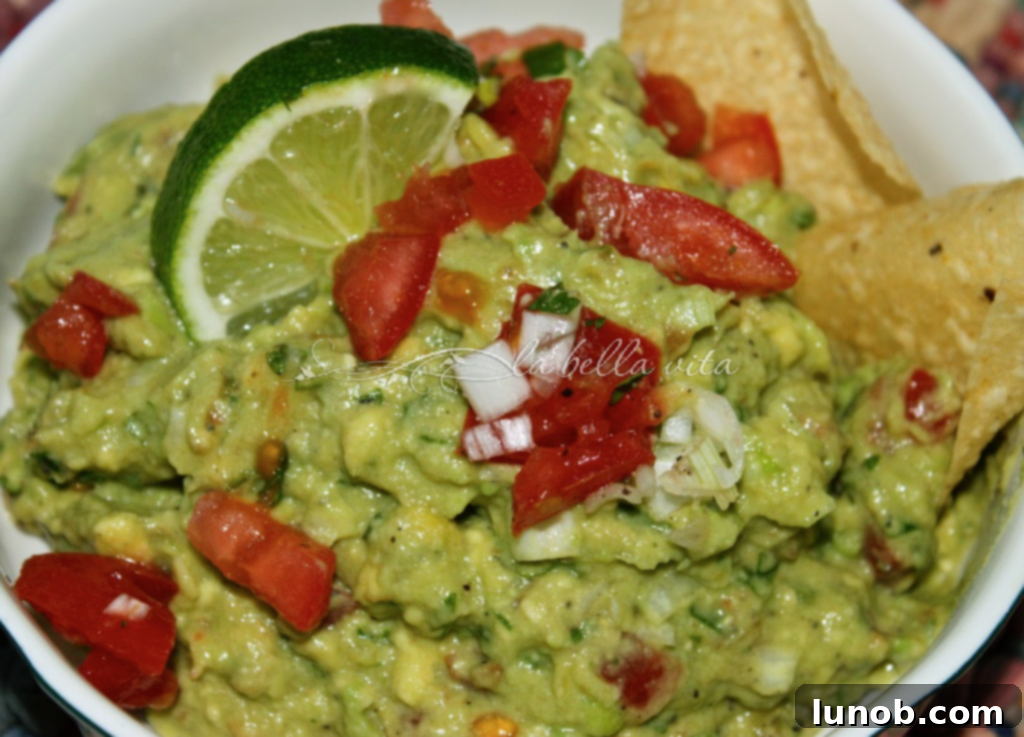 Winning Game Day Eats For Every Fan 4 Creamy homemade guacamole in a bowl with tortilla chips.