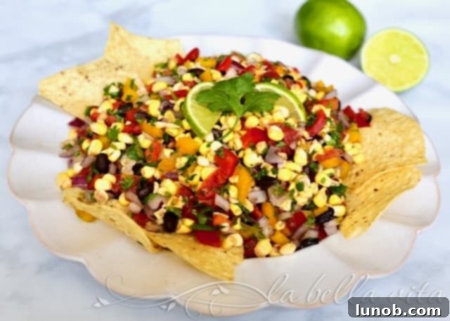 Winning Game Day Eats For Every Fan 5 A colorful bowl of fresh corn salsa with red onion, cilantro, and lime.