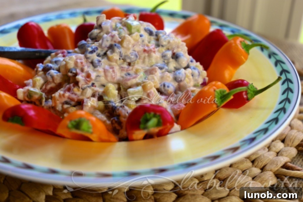 Winning Game Day Eats For Every Fan 7 Cheesy fiesta corn dip in a festive bowl with colorful toppings.