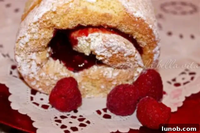 Raspberry Almond Jelly Roll with whipped cream and fresh raspberries