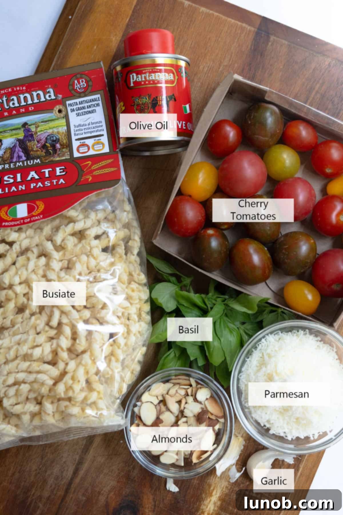 Sicilian Sun-Kissed Busiate 3 Fresh ingredients for making Pesto Trapanese: tomatoes, basil, garlic, and almonds.