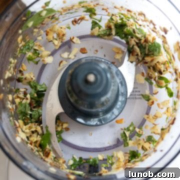 Sicilian Sun-Kissed Busiate 4 Basil, almonds, and garlic processed in a food processor.