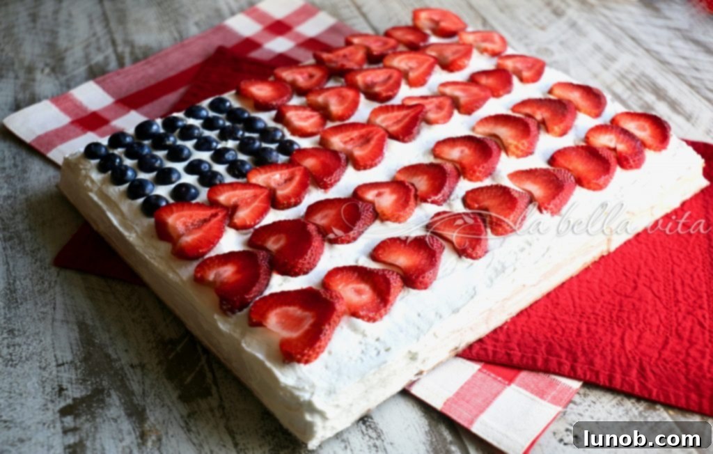 Ina Garten's Legendary Red White and Blue Flag Cake 3 Close-up of the Ina Garten-inspired Red, White, and Blue Flag Cake, showcasing the detailed arrangement of blueberries and strawberries for a festive and delicious dessert.