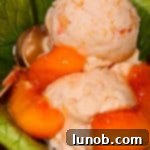 Scoops of fresh peach ice cream in a small dish