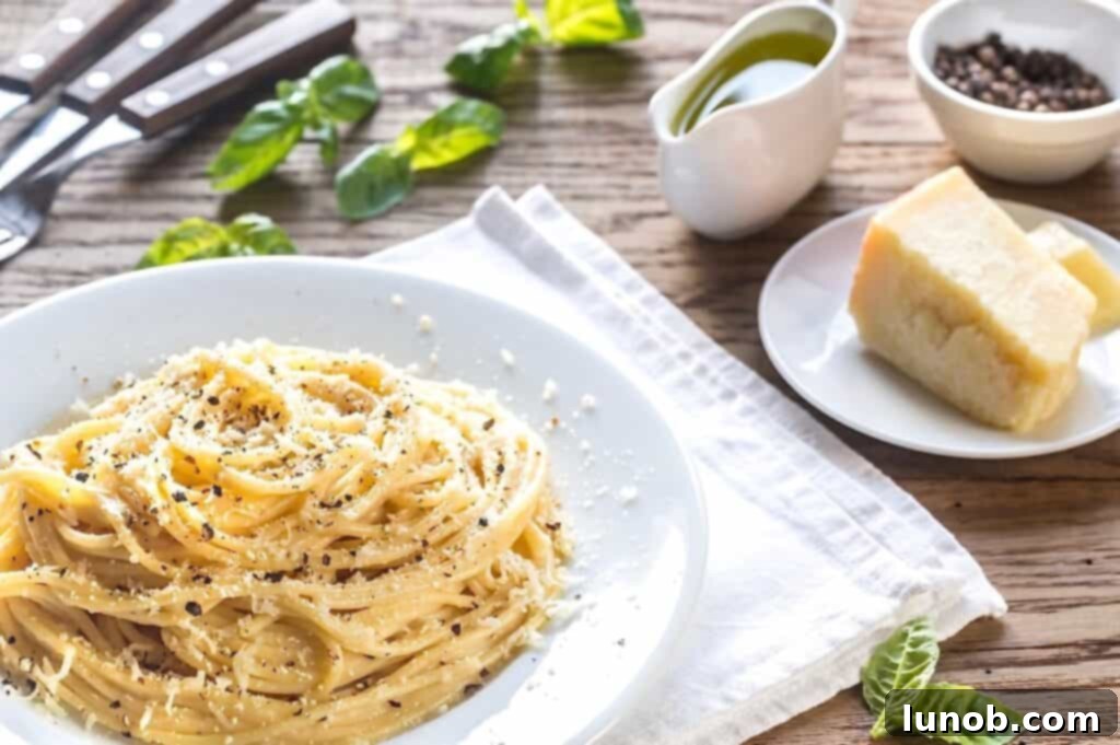 Cacio e Pepe: Rome's Iconic Pasta Perfection 2 A beautifully plated dish of Cacio e Pepe, showcasing thick spaghetti coated in a creamy cheese sauce with a generous sprinkle of black pepper.