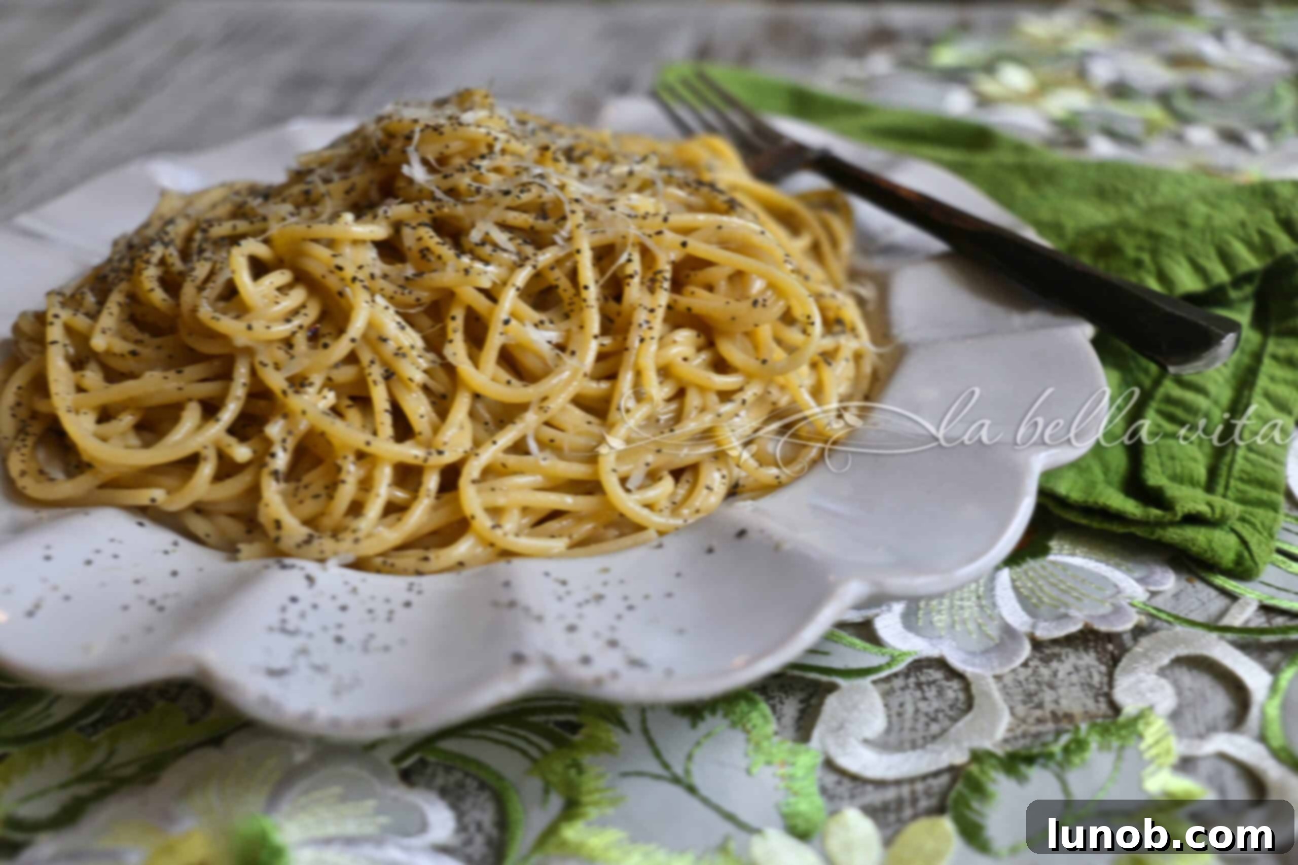 Cacio e Pepe: Rome's Iconic Pasta Perfection 14 A large serving of Cacio e Pepe with fresh black pepper and grated cheese.
