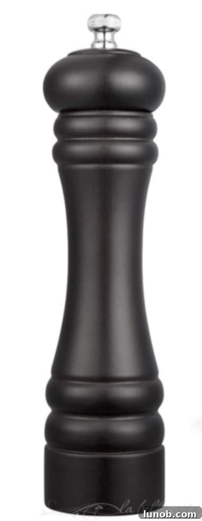 Cacio e Pepe: Rome's Iconic Pasta Perfection 7 Wooden pepper grinder with adjustable coarseness settings.