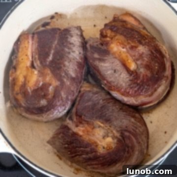 Perfectly seared short ribs with a deep golden-brown crust.