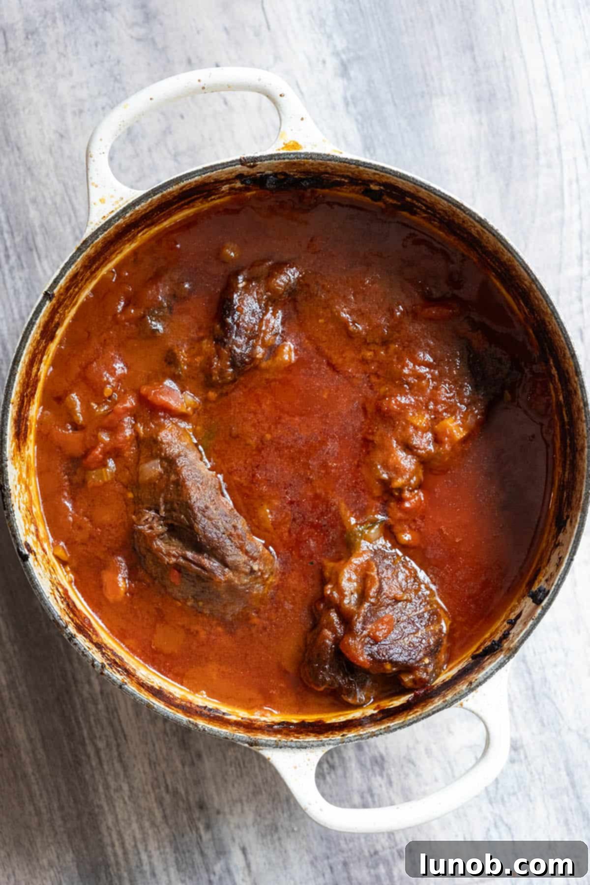 Tender short ribs braised in a rich tomato sauce, fresh from the oven.