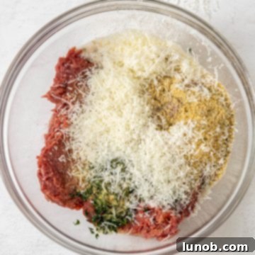 Rustic Italian Meatball & Escarole Soup 3 A bowl of mixed ground beef and seasonings, ready for shaping into Italian meatballs.