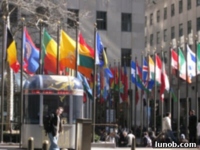 Big Apple Snapshot 12 Flags flying around Rockefeller Center Plaza on a beautiful, sunny-spring, 58 degree afternoon.
