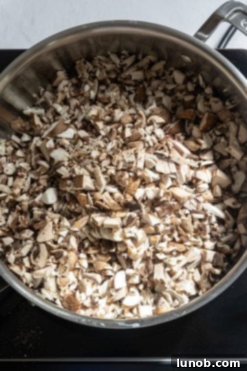 Velvet Truffle Mushroom Risotto 4 raw mushrooms sauteing in a pan with olive oil