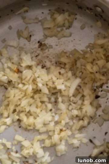 Velvet Truffle Mushroom Risotto 6 minced onions sauteing in a pan with olive oil