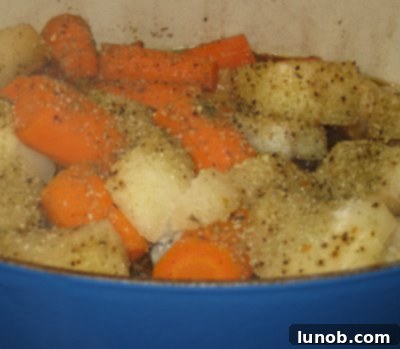 A perfectly cooked pot roast with fork-tender beef, carrots, and potatoes, ready to be served from the pot.