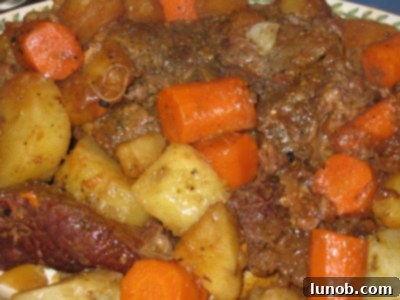 A serving of homemade pot roast, showcasing tender beef, root vegetables, and rich gravy on a plate.