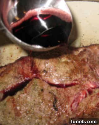 A glass of red wine, perfect for enjoying while cooking your pot roast.