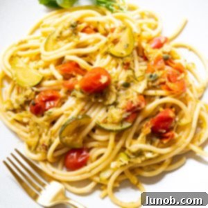 The final plated Italian Summer Pasta with Zucchini and cherry tomatoes, ready to be served.