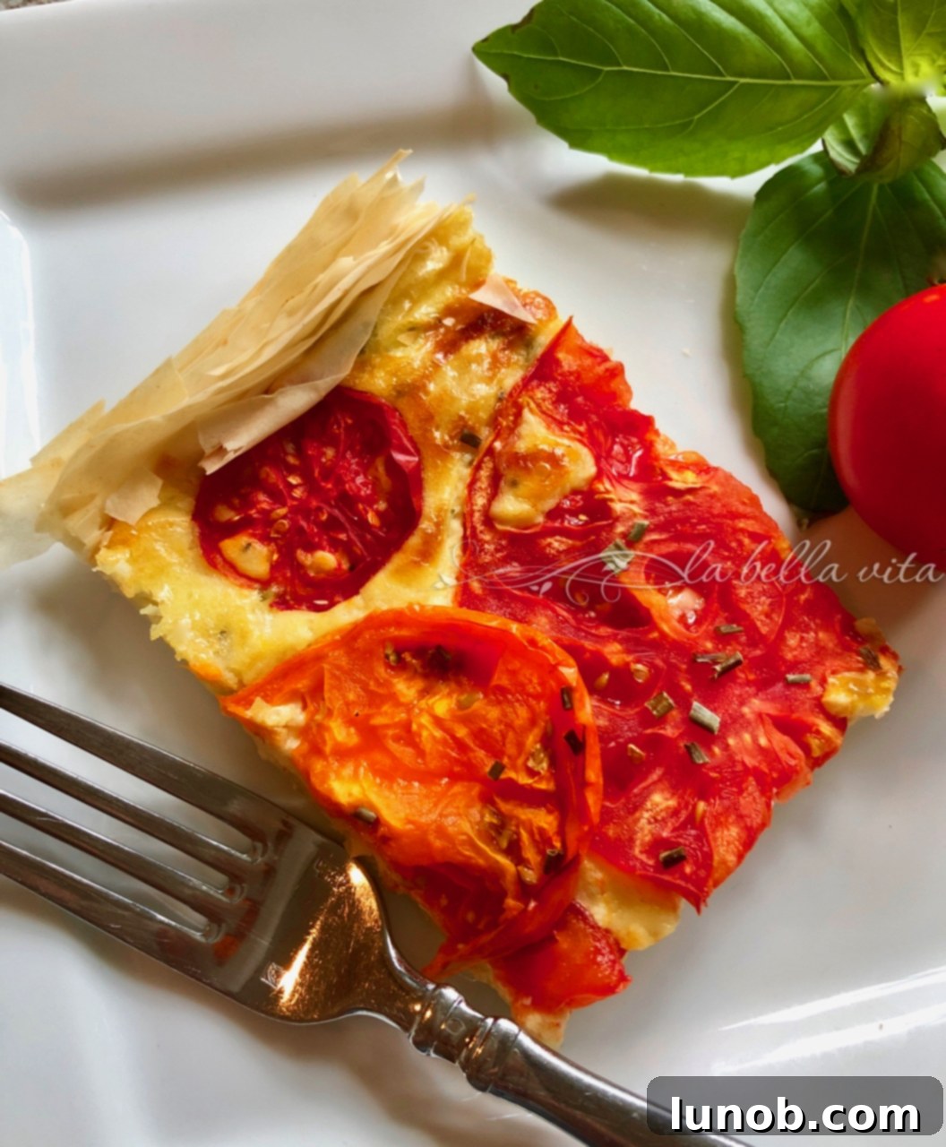 Sun-Kissed Heirloom Tomato and Italian Cheese Tart 3 Close-up of a slice of Heirloom Tomato and Italian Cheese Tart
