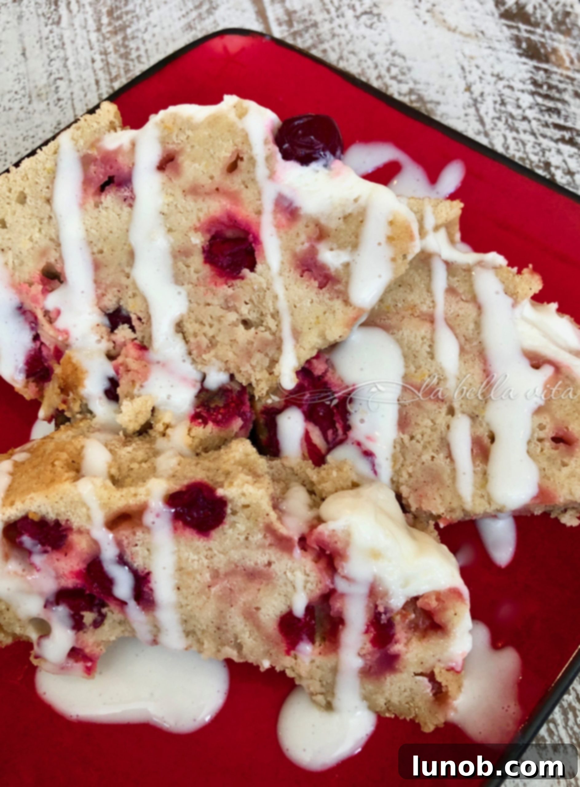 Sliced Italian Cranberry Orange Bundt Cake with cream cheese icing