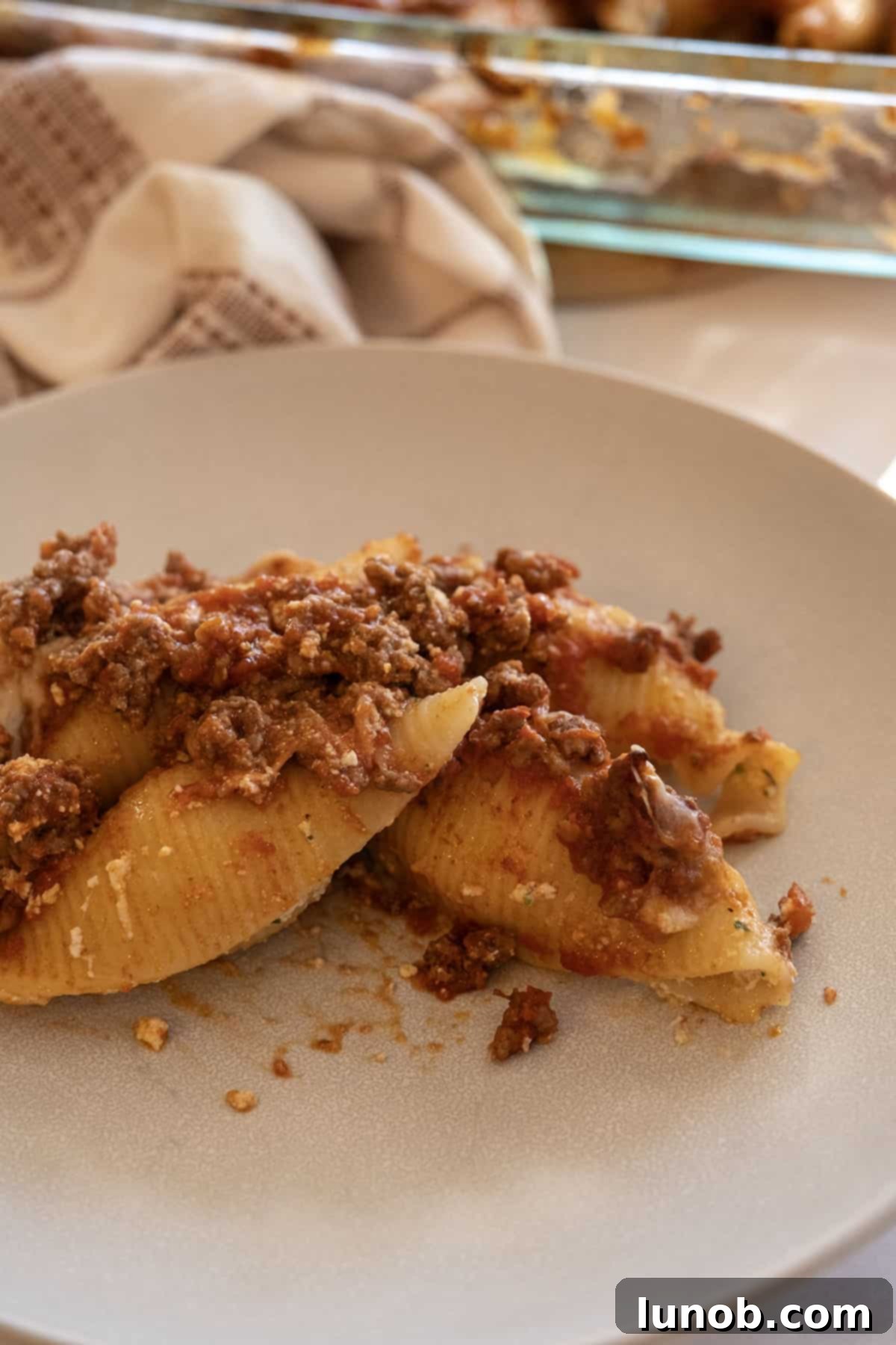 A serving of Italian stuffed shells with meat sauce and ricotta, ready to be enjoyed.