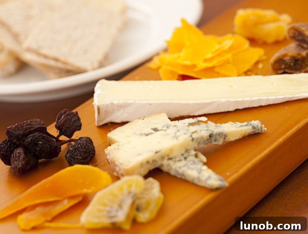 7 Insider Secrets for the Ultimate Charcuterie Board 6 Diverse selection of cheeses on a charcuterie board, including hard, soft, and crumbly varieties