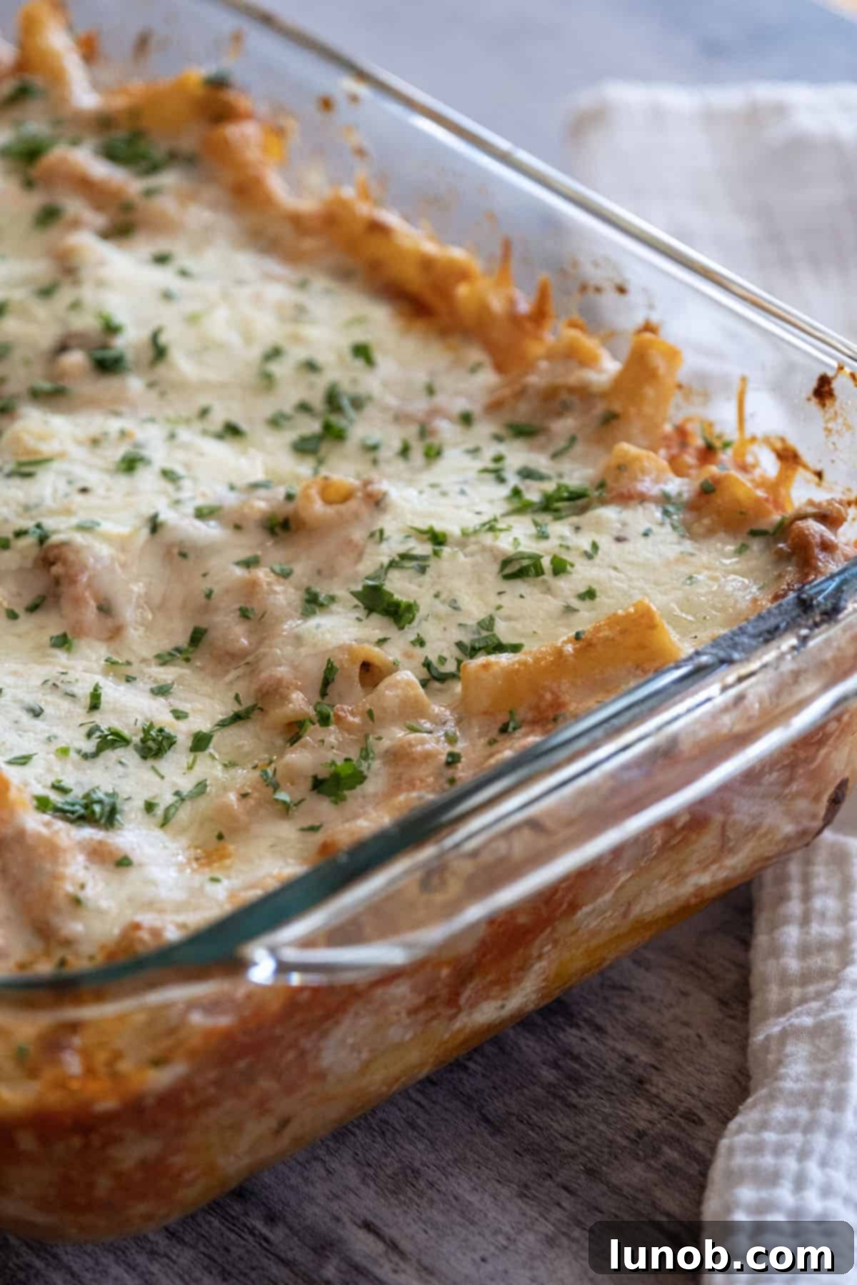 Finished Italian baked ziti, bubbling with cheese and rich sauce