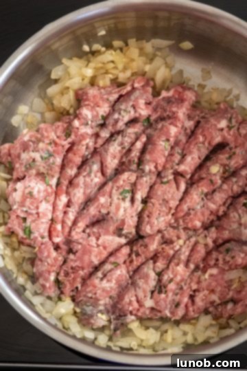Browning ground sausage with onions and garlic for baked ziti