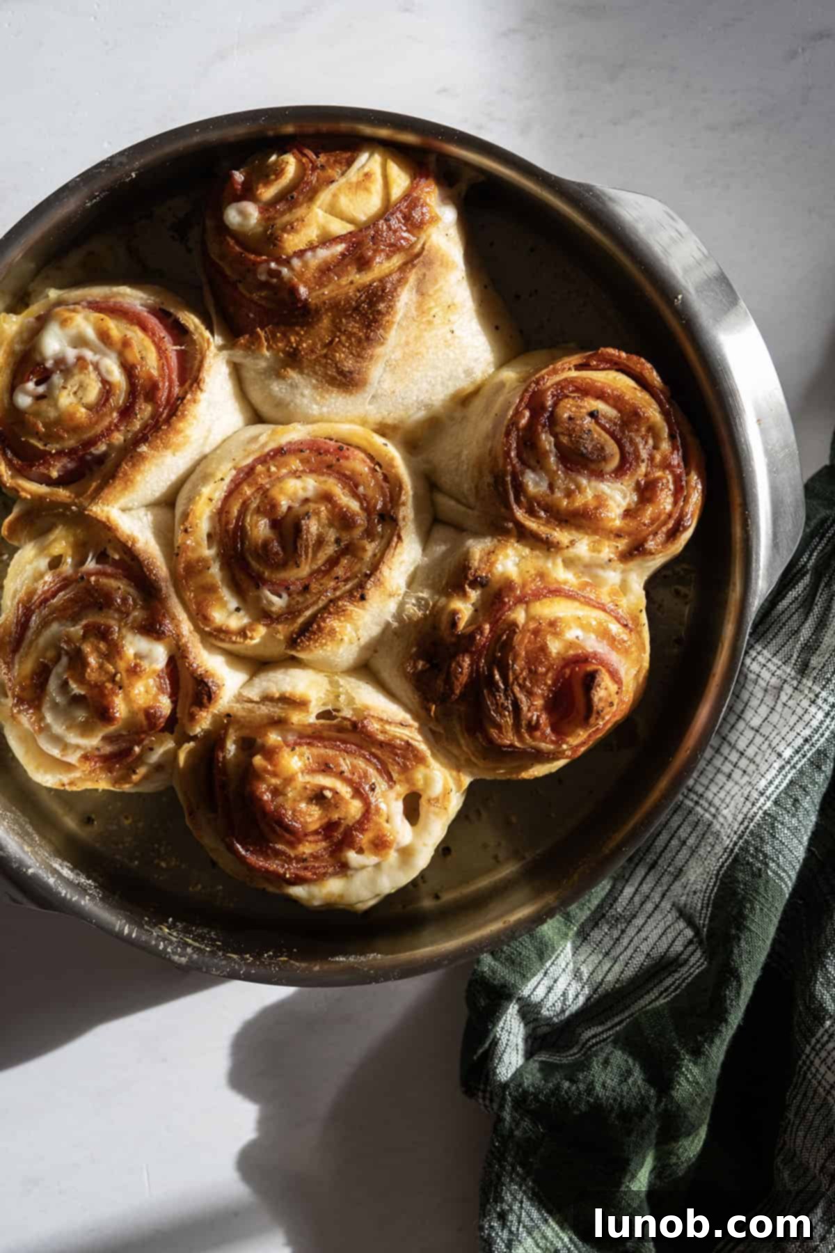 finished pepperoni stromboli (bread), golden brown and sliced to reveal the cheesy, meaty interior