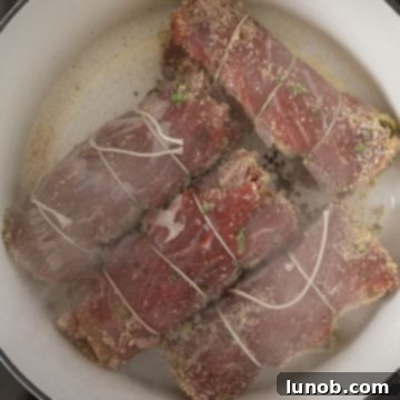 Searing the bracioles in a hot pot