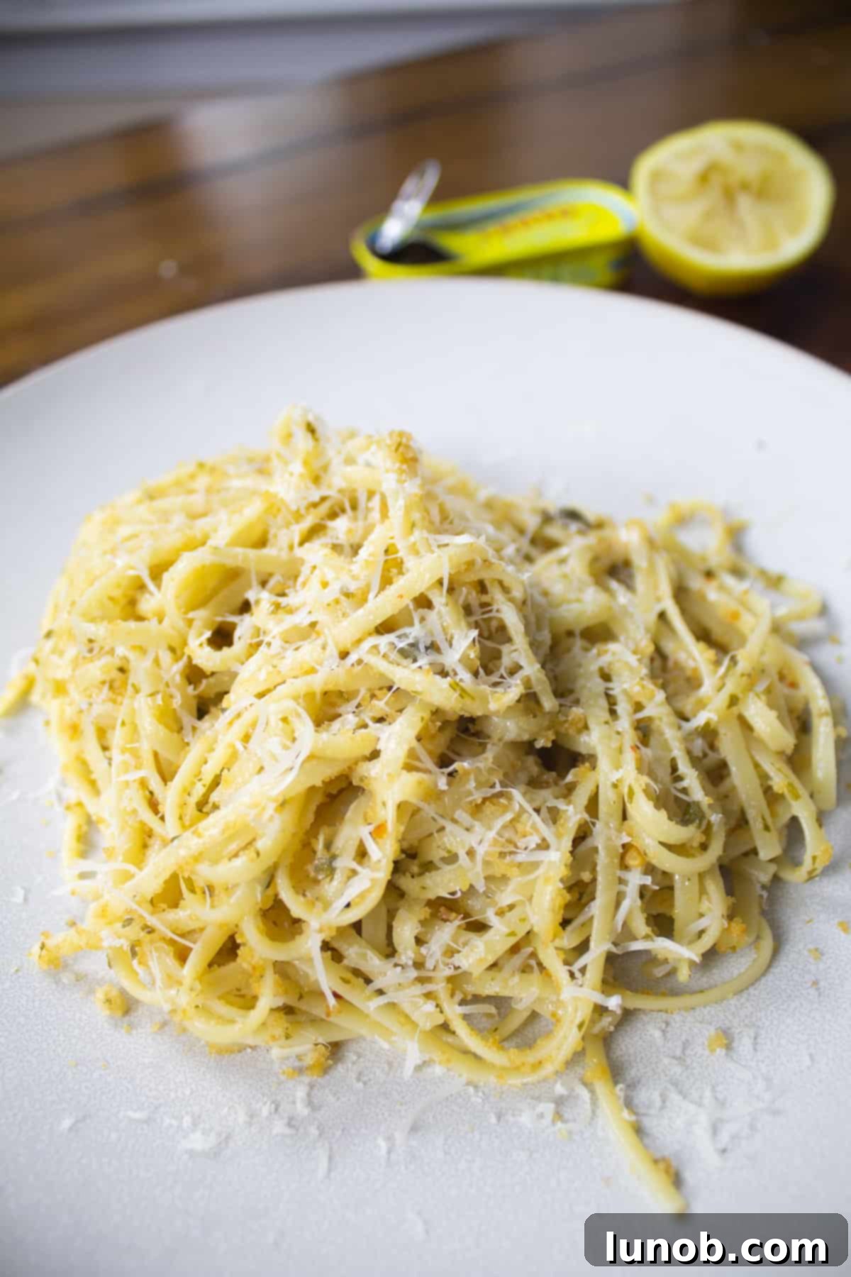 Close up of garlic anchovy pasta with a rich, savory sauce and fresh parsley